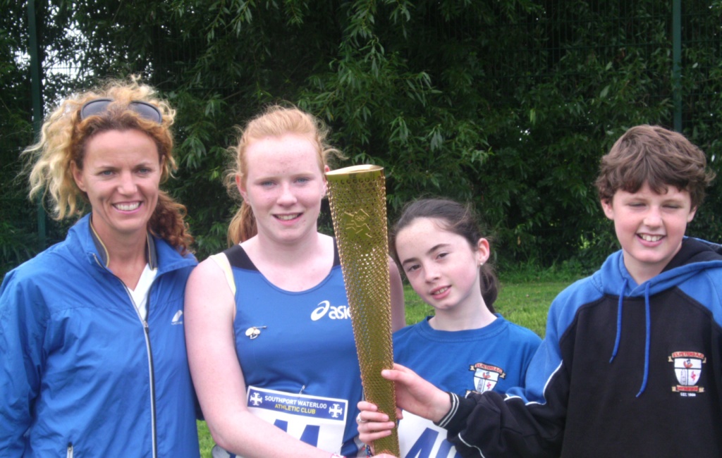 St Peter's AC athletes with Olympic Torch at Southport Waterloo AC Open Meet (Liverpool, September 2012)